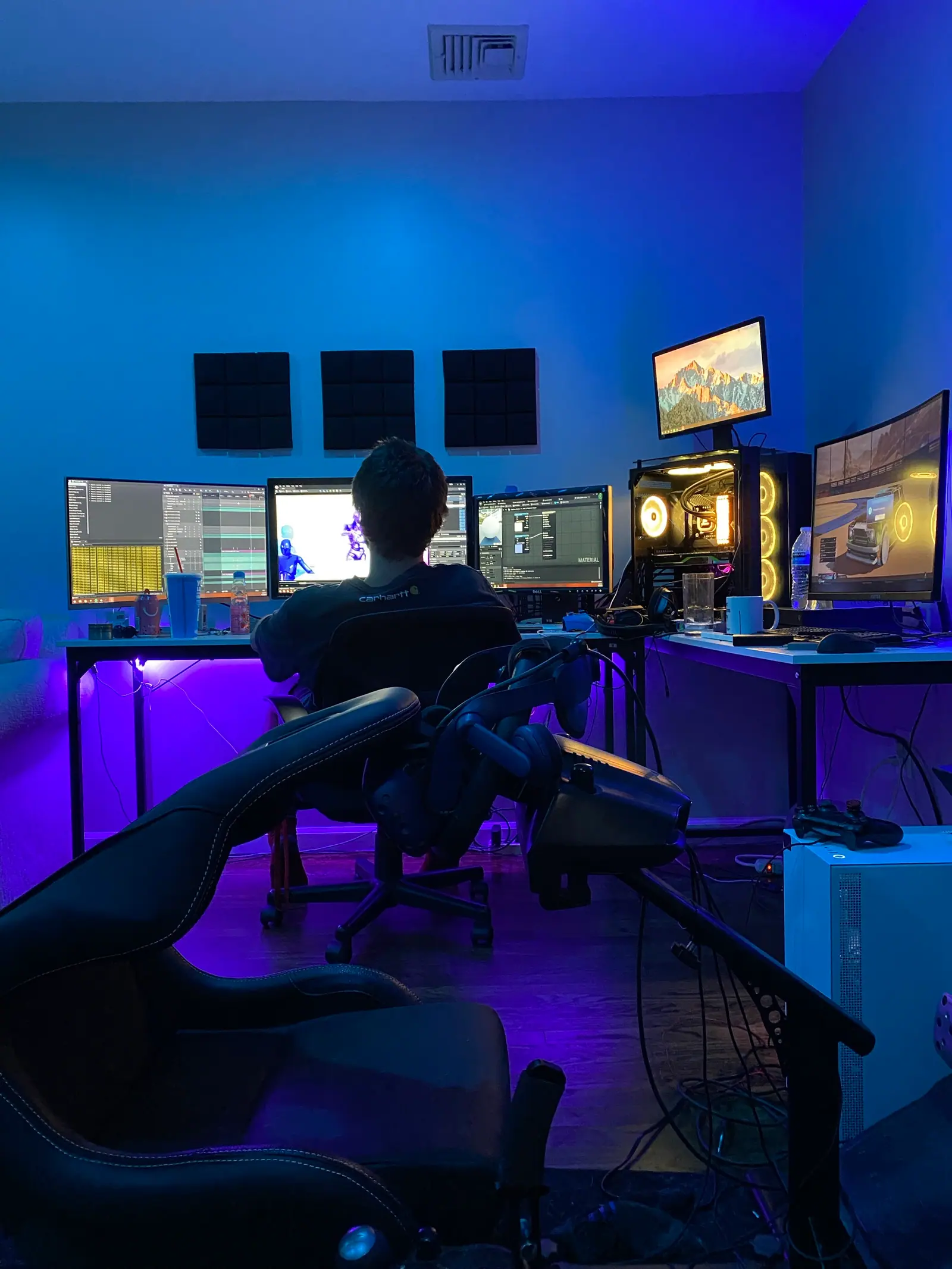The edit suite: a wall of monitors in blue and violet light