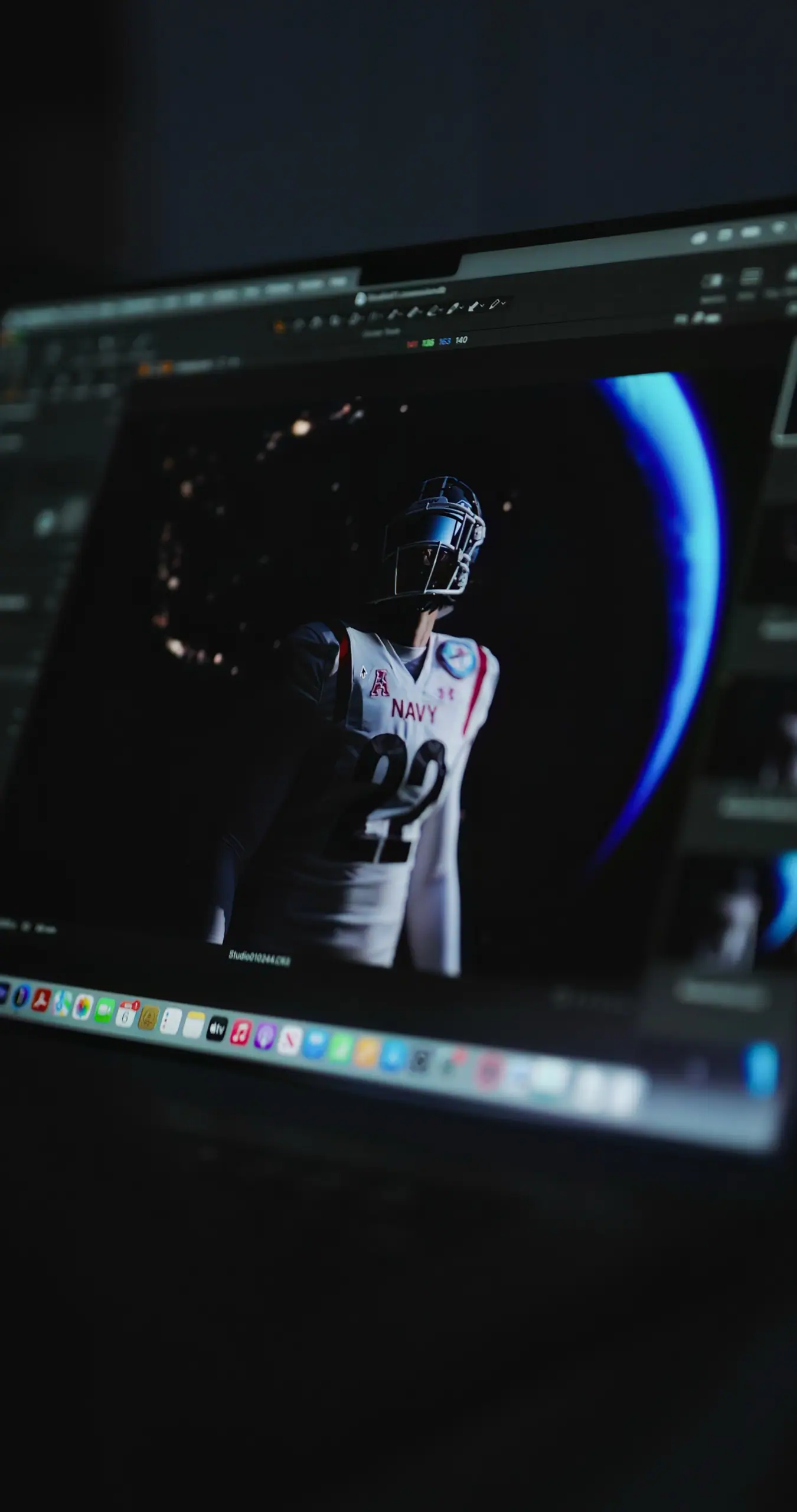 A Navy football frame on a laptop in the edit